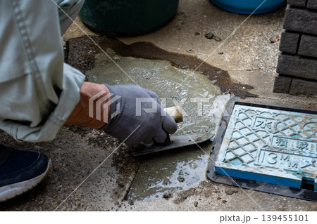 水道メーター周辺をモルタルで補修する作業 139455101
