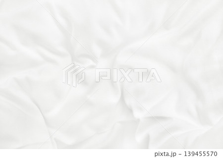 Close up top view of white bedding sheet and wrinkle messy blanket in bedroom after wake up in the morning. 139455570