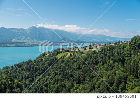 Scenic view of Lake Thun and Swiss Alps mountains in Switzerland on a sunny summer day Scenic view of Lake Thun and Swiss Alps mountains in Switzerland on a sunny summer day 139455601