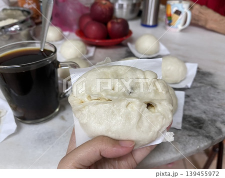 Hand Holding Steamed Baozi Bun Filled With Savory Minced Meat And Petai 139455972