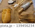 Baking ingredients and bread roll on burlap 139456234