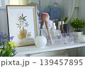White minimalist shelf organized with skincare products and makeup tools. 139457895