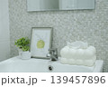 White ceramic sink with modern tissue box and decorative items in bathroom. 139457896