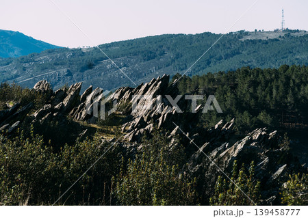Jagged rock formation on mountainside with communication tower Jagged rock formation on mountainside with communication tower 139458777