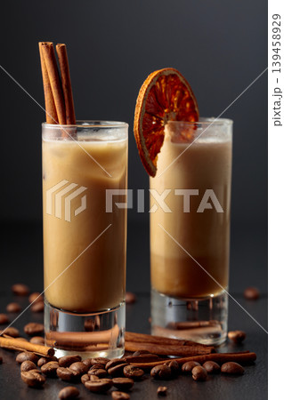 Cream and coffee liquor with ice in tall glass on a black background. Cream and coffee liquor with ice in tall glass on a black background. 139458929