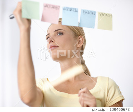 Business woman, writing and schedule planning on sticky notes or glass board for project or time management. Creative planner or worker with priority list, calendar or brainstorming of workflow ideas Business woman, writing and schedule planning on sticky notes or glass board for project or time management. Creative planner or worker with priority list, calendar or brainstorming of workflow ideas 139460678