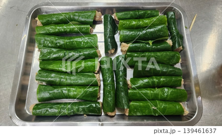Raw Vietnamese Bo La Lot Beef Rolls Wrapped in Piper Lolot Leaves on a Metal Tray Raw Vietnamese Bo La Lot Beef Rolls Wrapped in Piper Lolot Leaves on a Metal Tray 139461637