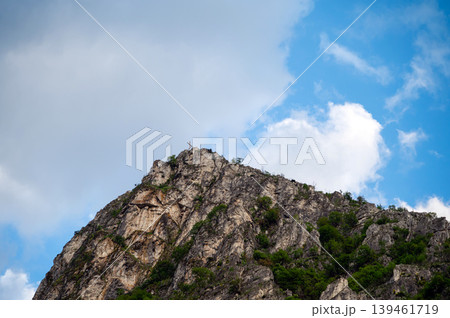 Rocks rise high in Matka Canyon near Skopje with clouds above and greenery on the slopes Rocks rise high in Matka Canyon near Skopje with clouds above and greenery on the slopes 139461719