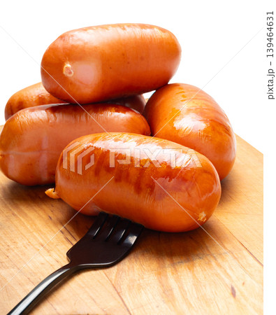 Appetizing grilled sausages on a cutting board close-up Appetizing grilled sausages on a cutting board close-up 139464631