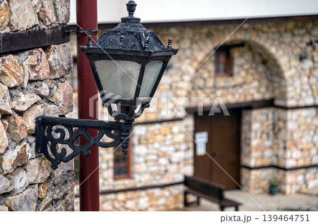 Lamp post stands near stone wall in Skopje, North Macedonia on a clear day 139464751