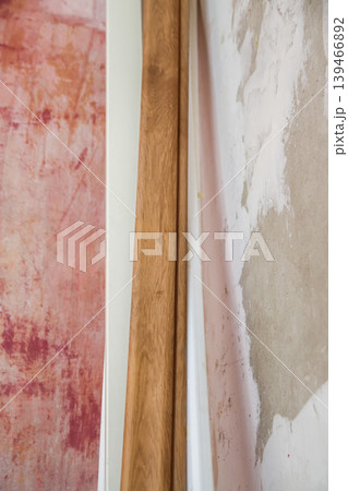 Interior space with rough plaster applied to scratched walls in repair process. Represents restoration, building maintenance, and renovation workflow. Interior space with rough plaster applied to scratched walls in repair process. Represents restoration, building maintenance, and renovation workflow. 139466892