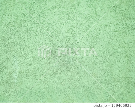 Soft green textured concrete wall with distressed and weathered finish. Can be used as a background for urban design, branding, and digital artwork. Soft green textured concrete wall with distressed and weathered finish. Can be used as a background for urban design, branding, and digital artwork. 139466923