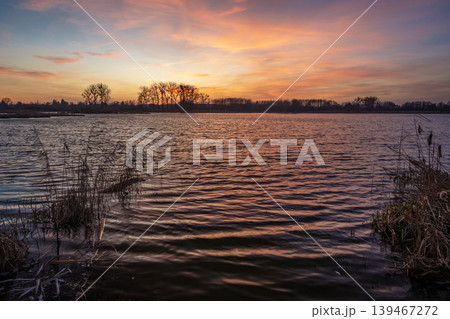 Sunset over a calm lake Sunset over a calm lake 139467272