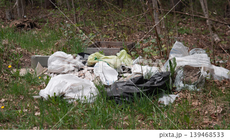 New Green Shoots Surrounding Dumped Bags, Contrast Between Fresh Seedlings And Plastic Waste, Hopeful Regeneration Threatened By Pollution, Scene Calls For Community Restoration And Cleanup Action New Green Shoots Surrounding Dumped Bags, Contrast Between Fresh Seedlings And Plastic Waste, Hopeful Regeneration Threatened By Pollution, Scene Calls For Community Restoration And Cleanup Action 139468533