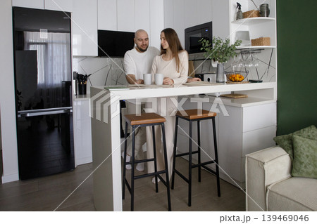 Happy woman and man together. Couple in kitchen in home for morning. 139469046