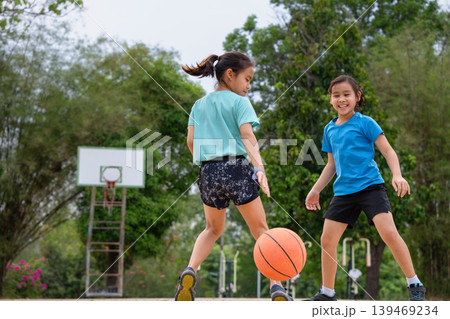 Active students practicing basketball drills during physical education class or after school sports program. Active students practicing basketball drills during physical education class or after school sports program. 139469234