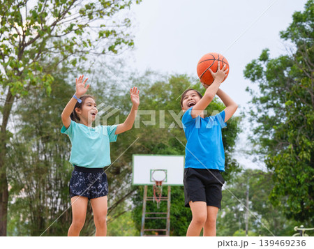Active students practicing basketball drills during physical education class or after school sports program. 139469236