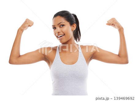 Flexing arms, portrait and woman with fitness, strong muscle and wellness isolated on a white studio background. Face, person and model with progress, endurance and healthy with confidence and smile 139469692