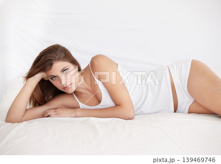 Portrait, beauty and woman in bedroom, home and underwear to relax in the morning on mockup space. Face, serious girl lying in bed and young person on sheets, confident and comfortable in Australia Portrait, beauty and woman in bedroom, home and underwear to relax in the morning on mockup space. Face, serious girl lying in bed and young person on sheets, confident and comfortable in Australia 139469746