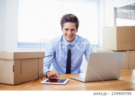 Businessman, moving boxes and smile for laptop, entrepreneur and online logistics for courier. Happy male person, professional and delivery for company distribution, package and shipment by internet Businessman, moving boxes and smile for laptop, entrepreneur and online logistics for courier. Happy male person, professional and delivery for company distribution, package and shipment by internet 139469780