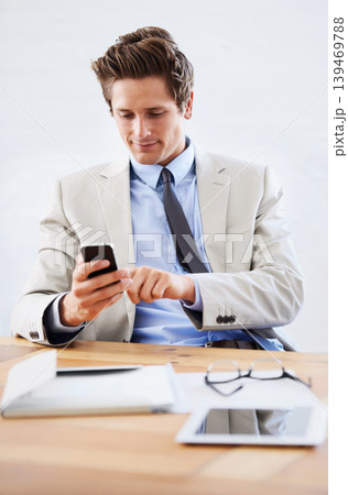 Businessman, phone and networking or texting in office, connection and contact for company. Male person, professional and communication or mobile application, technology and smile for discussion Businessman, phone and networking or texting in office, connection and contact for company. Male person, professional and communication or mobile application, technology and smile for discussion 139469788