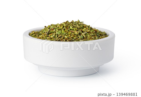 Dried oregano spice in white bowl for seasoning Dried oregano spice in white bowl for seasoning 139469881