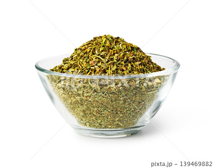Dry oregano herbs in glass bowl on white 139469882