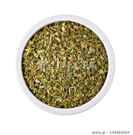 Dried oregano seasoning in white bowl, cooking ingredient Dried oregano seasoning in white bowl, cooking ingredient 139469884