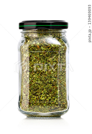 Dried oregano glass jar on white background Dried oregano glass jar on white background 139469893