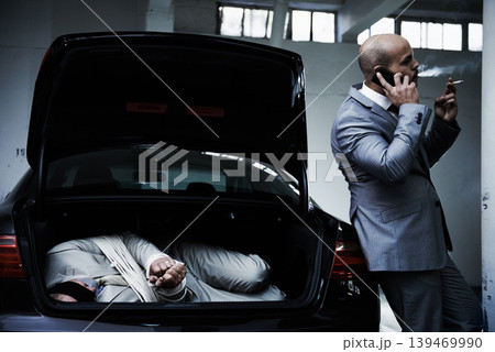 Phone call, car and gangster with hostage in trunk for negotiation, kidnapping danger and crime. Mafia, ransom criminal and business person in boot for abduction, money and terrorism in parking lot Phone call, car and gangster with hostage in trunk for negotiation, kidnapping danger and crime. Mafia, ransom criminal and business person in boot for abduction, money and terrorism in parking lot 139469990