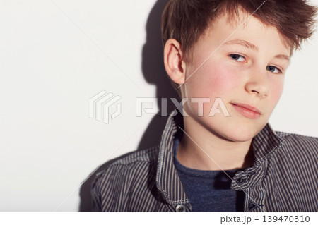 Teenager, portrait and boy with fashion in studio, white background with a smirk or smile. Cool, style and child with confidence in trendy clothes, outfit and pride in personality on backdrop Teenager, portrait and boy with fashion in studio, white background with a smirk or smile. Cool, style and child with confidence in trendy clothes, outfit and pride in personality on backdrop 139470310
