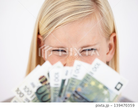 Money, finance and lottery winner with a woman closeup in studio on a white background for profit or increase. Eyes, economy or investment and an excited young person with cash for financial freedom Money, finance and lottery winner with a woman closeup in studio on a white background for profit or increase. Eyes, economy or investment and an excited young person with cash for financial freedom 139470359
