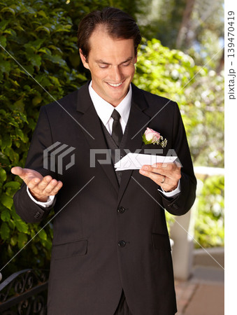 Man, vows and outdoor at wedding ceremony for marriage commitment, promise speech or romance party. Male person, paper and reading as groom for partnership celebration, relationship trust or love 139470419