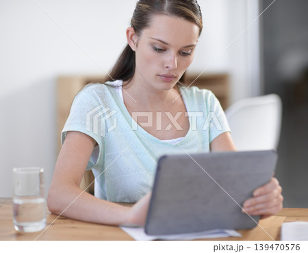 Creative, business woman and scroll on tablet in office for planning research, information and social network in startup agency. Serious designer review digital news, software and app with technology Creative, business woman and scroll on tablet in office for planning research, information and social network in startup agency. Serious designer review digital news, software and app with technology 139470576