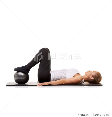 Yoga, exercise and woman on floor with ball for pilates, wellness care and health in studio. Gym, training and girl on mat with workout, lying and muscle fitness isolated on white background. 139470740