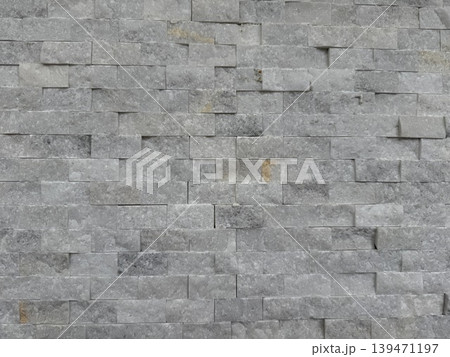 Stone brick wall texture creating rough gray background with unique pattern Stone brick wall texture creating rough gray background with unique pattern 139471197