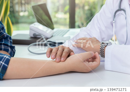 Doctor examining patient pulse by hands. Healthcare and medical service. Doctor examining patient pulse by hands. Healthcare and medical service. 139471271