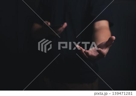 Male empty hand open a palm up on a dark background. Male empty hand open a palm up on a dark background. 139471281