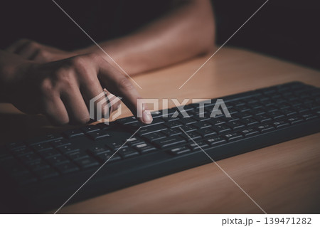 Closeup shot of man hand pressing enter key on computer keyboard. 139471282