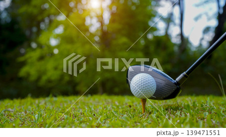 Golf clubs and balls on a green lawn in a beautiful golf course with morning sunshine. 139471551