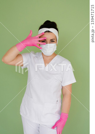Female Physician Placing Hand in Pink Glove 139471715