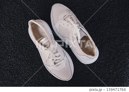 Fresh beige leather sneakers without brand marks displayed. For design templates online shops and sustainability-themed marketing. Clean blank sneakers 139471768
