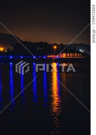 Moonlight Over Sea Waves Full Moon Glow ocean waves on sandy beach at night wooden pier. The moon illuminates water surface. Concept of beach vacation slowing down on seacoast 139471803