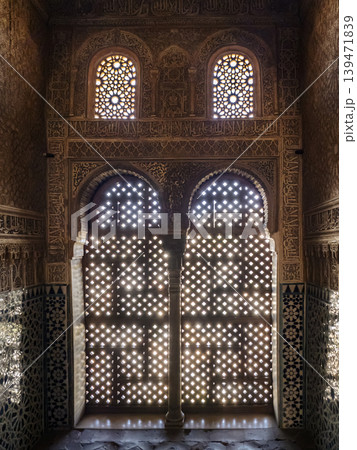 Ornate Moorish Stone Lattice Windows and Carved Islamic Arch Interior With Geometric Motifs, Alhambra, Granada Ornate Moorish Stone Lattice Windows and Carved Islamic Arch Interior With Geometric Motifs, Alhambra, Granada 139471839