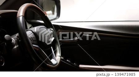 EV Car steering wheel. Modern car interior with luxury steering wheel dashboard and digital monitor controls. Steering wheel and automotive cabin. Car technology comfort and premium design in EV car. EV Car steering wheel. Modern car interior with luxury steering wheel dashboard and digital monitor controls. Steering wheel and automotive cabin. Car technology comfort and premium design in EV car. 139471985