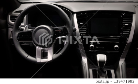 EV Car steering wheel. Modern car interior with luxury steering wheel dashboard and digital monitor controls. Steering wheel and automotive cabin. Car technology comfort and premium design in EV car. EV Car steering wheel. Modern car interior with luxury steering wheel dashboard and digital monitor controls. Steering wheel and automotive cabin. Car technology comfort and premium design in EV car. 139471992