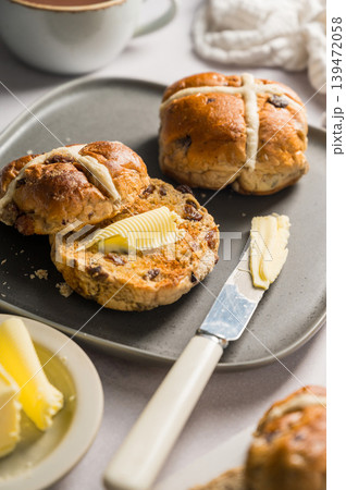 Cross Buns with butter in a plate. Breakfast concept. Close up shot. Easter treat buns Cross Buns with butter in a plate. Breakfast concept. Close up shot. Easter treat buns 139472058