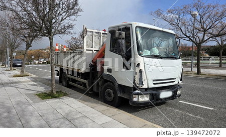 White iveco work truck parked at urban road repair site for pipeline transport and construction background 139472072