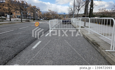 Closed road lane with white barriers and 20 speed sign for traffic control and temporary closure used in urban maintenance and safety signage backgrounds Closed road lane with white barriers and 20 speed sign for traffic control and temporary closure used in urban maintenance and safety signage backgrounds 139472093