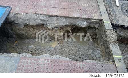 Rectangular excavated trench in sidewalk for drainage pipe installation and road repair background for infrastructure work signs Rectangular excavated trench in sidewalk for drainage pipe installation and road repair background for infrastructure work signs 139472182